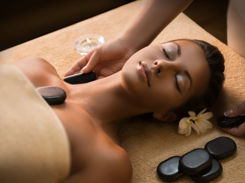 Massage with hot basalt stones. Beautiful deep charming light.